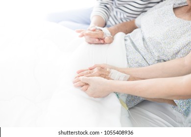 Hand In Hand, Young Female Holding Hand Of Her Mother, Palliative Care In Hospital