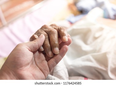 Hand In Hand, Young Man Holding Hand Of  Old Patient, Dry And Wrinkle Skin, Palliative Care