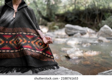 Hand Of A Young Man Meditating By The River Sitting On A Rock. Close Up