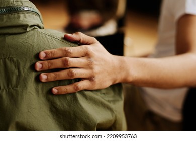 Hand of young supportive man consoling his friend or one of attendants with post traumatic syndrome caused by dramatic life event - Powered by Shutterstock