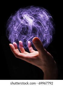 Hand Of A Young Wizard Creating A Magical Sphere.