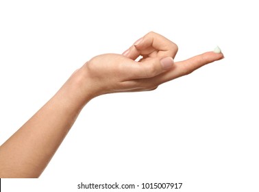 Hand of young woman with cream on finger, against white background