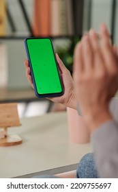 Hand Of Young Woman Holding Smartphone With Blank Green Screen