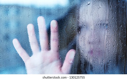 Hand Of Young  Woman  Melancholy And Sad  At The Window In The Rain