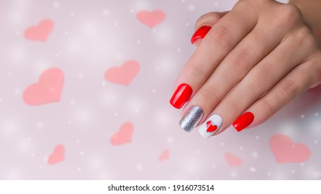 The Hand Of A Young Woman. The Nails Are Covered With Red Gel Polish For Valentine's Day. Nail Art And Design Ideas, Heart.