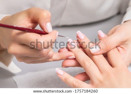 Similar – Frau in einem Nagelsalon, die eine Maniküre mit Nagelfeile erhält.