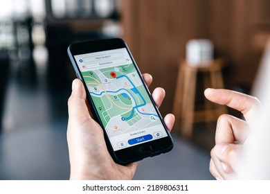 Hand of young woman searching location in map online on smartphone. - Shutterstock ID 2189806311