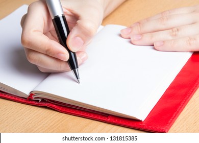 Hand Of Young Woman Taking Notes In Notebook