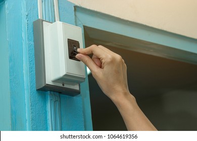 Hand Of Young Woman Turning Off Circuit Breaker In Home