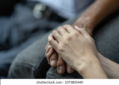 Hand of younger woman holding hand elderly man, helping hands, take care for elderly concept.