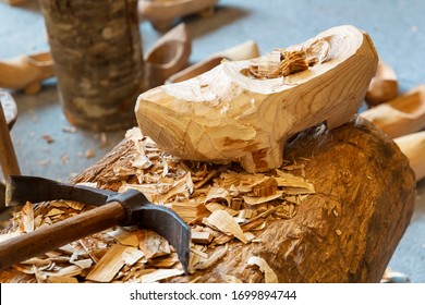 Handamade rustic wooden clog, usually with small studs on the sole and finished with a pointed upturned toe.