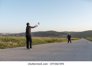 Handball Players Playing Game Outside.Senior Father And Teenager Son Playing With Ball On Nature At Sunset On Summer Day.Real Family Having Fun,staycation During Corona Virus Quarantine, Summer Day.