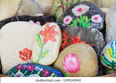 Handcraft artist paints on stone. Authentic pictures on natural stones for souvenirs and home decoration, greek domestic life - Powered by Shutterstock
