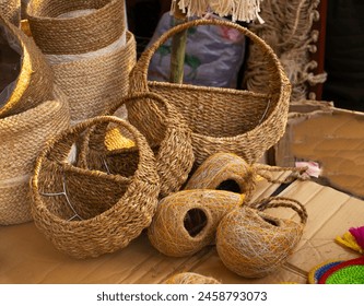 Handcrafted bird nest on shop for sale. Traditional straw, bamboo. Cane made handcrafts display. A pile of handmade traditional woven baskets made from straw, natural fiber, for sale at the market. - Powered by Shutterstock