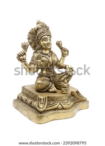 handcrafted brass idol of hindu goddess lakshmi stitting with multiple arms, symbol of wealth and prosperity isolated in a white background