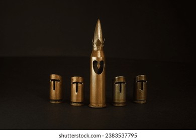 A hand-crafted chess set made of bullet shells (7.62x54 mm and 7.62x39 mm caliber). Dark background. The small depth of field