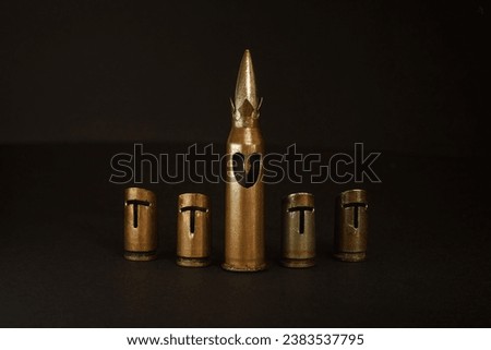 A hand-crafted chess set made of bullet shells (7.62x54 mm and 7.62x39 mm caliber). Dark background. The small depth of field