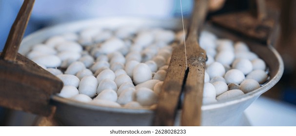 Handcrafted Elegance: Extracting Silk Threads the Traditional Way.