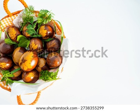 Handcrafted red Easter eggs with botanical patterns on white background