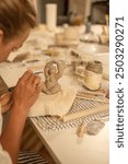 Handcrafting a Clay Sculpture of a Woman During Pottery Workshop