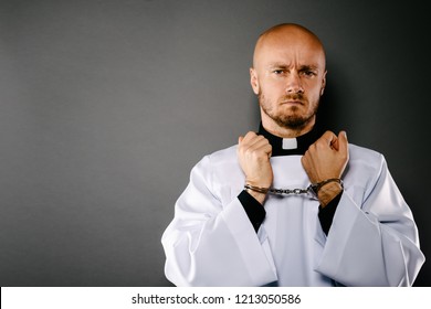 Handcuffed Catholic priest. Church harassment and crime concept