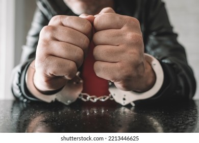 handcuffed hand is strapped inside interrogation room. the concept of arrest and incarceration. A prisoner in prison. interrogation in prison. criminal is being interrogated. conducting interrogations
