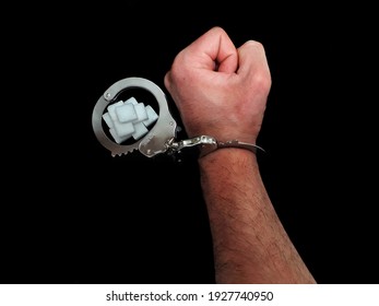 Handcuffed Man Is Addicted To Sugar And Cocaine, Sugar Is More Addictive Than Cocaine, White Sugar Cube And Cocaine Drug Powder Pile Are Linked With Handcuffed Addicted Man Hand