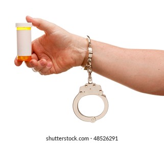 Handcuffed Man Holding Blank Medicine Bottle Isolated On A White Background.