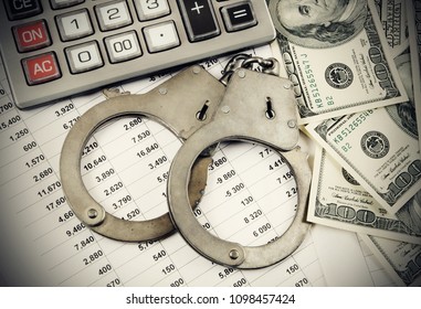 Handcuffs, Calculator And Dollars On Documents, Financial Fraud Theme