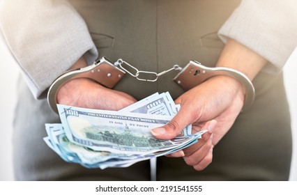 . Handcuffs, Dollars And A Business Woman Arrested For Theft At Work. Money, Crime And Punishment For Fraud With Female Lawyer In Prison. Cash, Restraints And A Criminal Trying To Bribe An Officer.