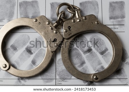 Handcuffs and fingerprints close up