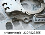 Handcuffs laying on fingerprint card with money - concept for arrest bail money 