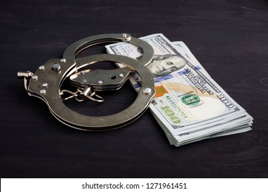 Handcuffs And Money. Dollars For Bail Bonds.