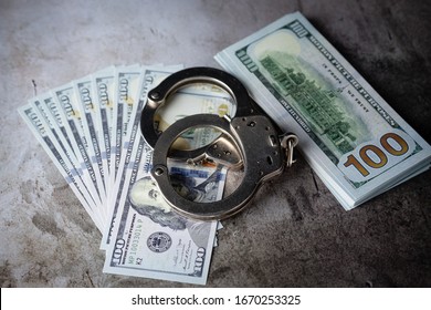 Handcuffs On $100 Bills On Concrete Floor For Crime Or DUI