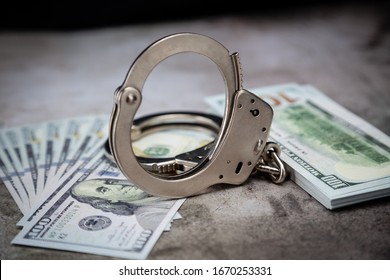 Handcuffs On $100 Bills On Concrete Floor For Crime Or DUI