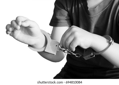 Handcuffs on children's hands, a toy, isolated
