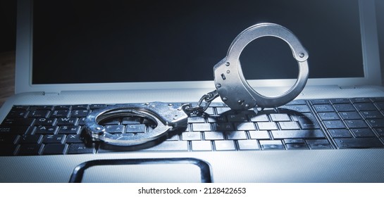 Handcuffs On The Computer Keyboard. Cyber Crime