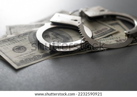 The handcuffs are on hundred-dollar bills. Power and bribery. Criminal ransom. Criminal earnings. Business concept. The concept of wealth