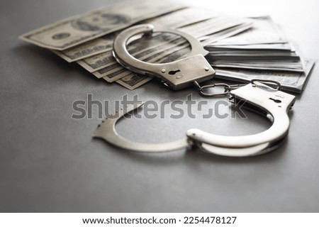 The handcuffs are on hundred-dollar bills. Power and bribery. Criminal ransom. Criminal earnings. Business concept. The concept of wealth