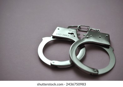 handcuffs on the purple background