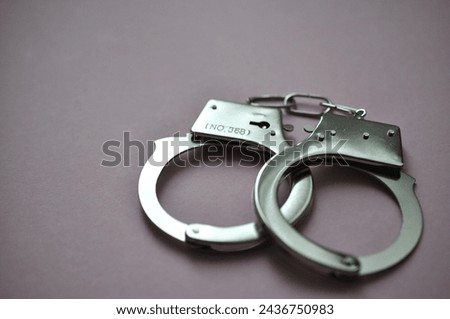 handcuffs on the purple background