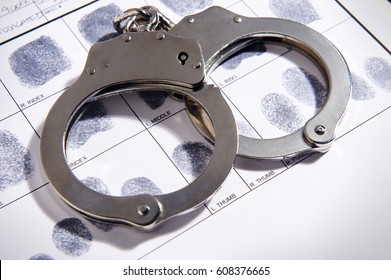 Handcuffs on top of a set of fingerprints