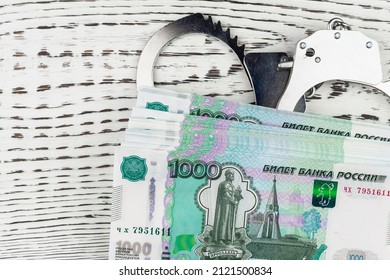 Handcuffs And Russian Money. Concept. Russian Mafia. Crime And Theft.