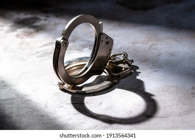 Handcuffs In Shadow Light With And Possible Jail For DUI Prisoner