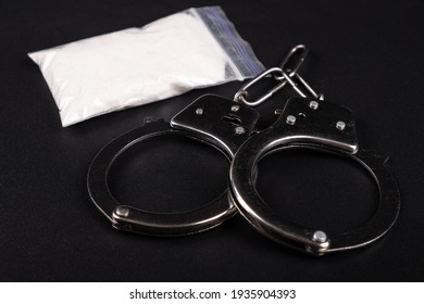 Handcuffs And White Powder Closeup ,drug Arrest.