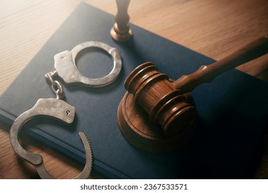 Handcuffs and wooden gavel. Crime, legal and violence concept. - Powered by Shutterstock