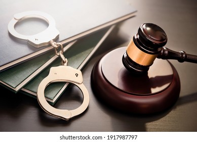 Handcuffs and wooden gavel. Crime and violence concept. - Shutterstock ID 1917987797