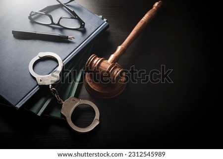 Handcuffs and wooden gavel. Crime and violence.