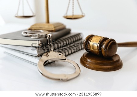 handcuffs and wooden mallet legal lawyer crime and violence concept.