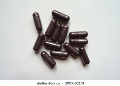 Handful Of Dark Purple Capsules Of Bilberry Extract Dietary Supplement